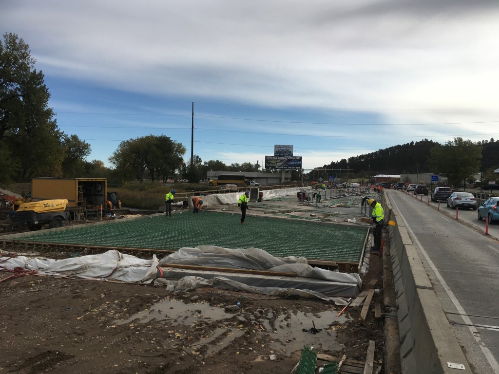 Tying rebar for approach slab on the west side of Rapid Creek Bridge, Omaha Street, Rapid City, South Dakota, Thursday, October 14, 2021.